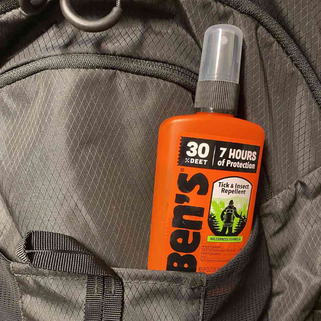 Ben's 30 Tick & Insect Repellent 3.4 oz. Pump Spray sitting in pocket of black backpack