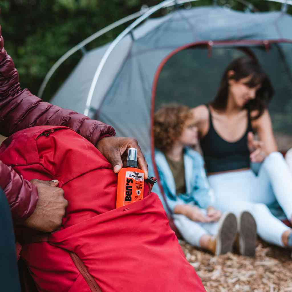 Ben's Tick Repellent 3.4 oz. Pump Spray person pulling from red backpack in front of family in tent