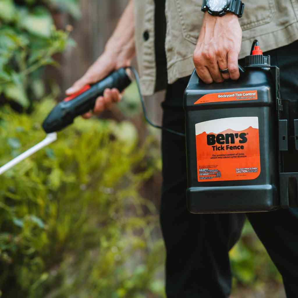 Ben's Tick Fence Backyard Tick Control Spray person using in yard