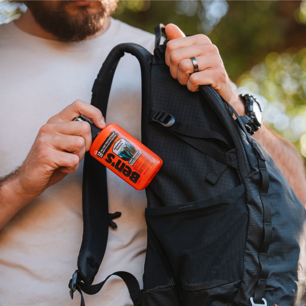 Ben's Adventure Formula 3.4 oz man putting in backpack