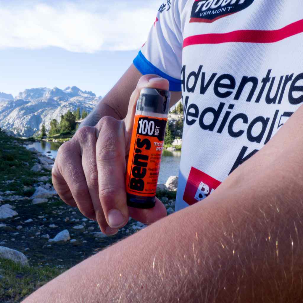 Ben's 100 Tick & Insect Repellent 0.5 oz. Mini Spray in use on arm in front of mountains