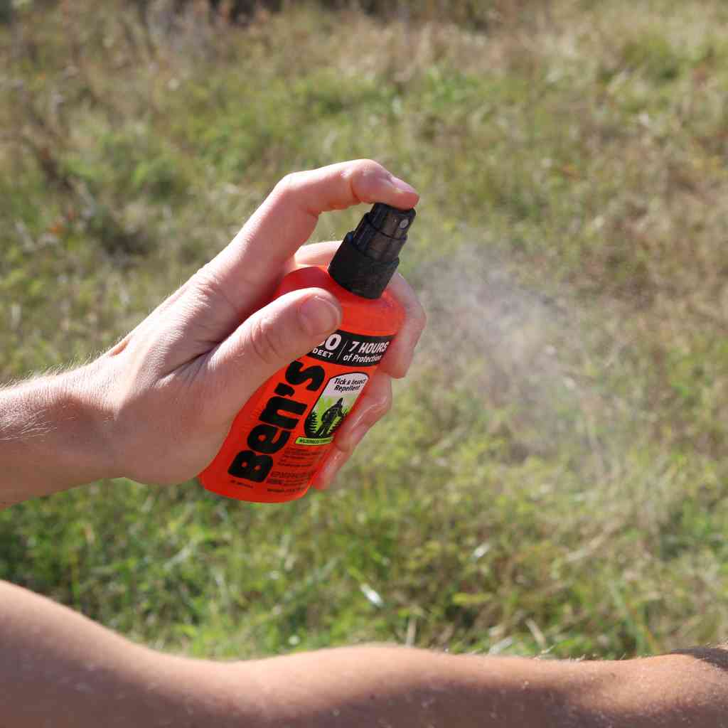 Ben's 30 Tick & Insect Repellent 3.4 oz. Pump Spray person spraying on arm in front of grass