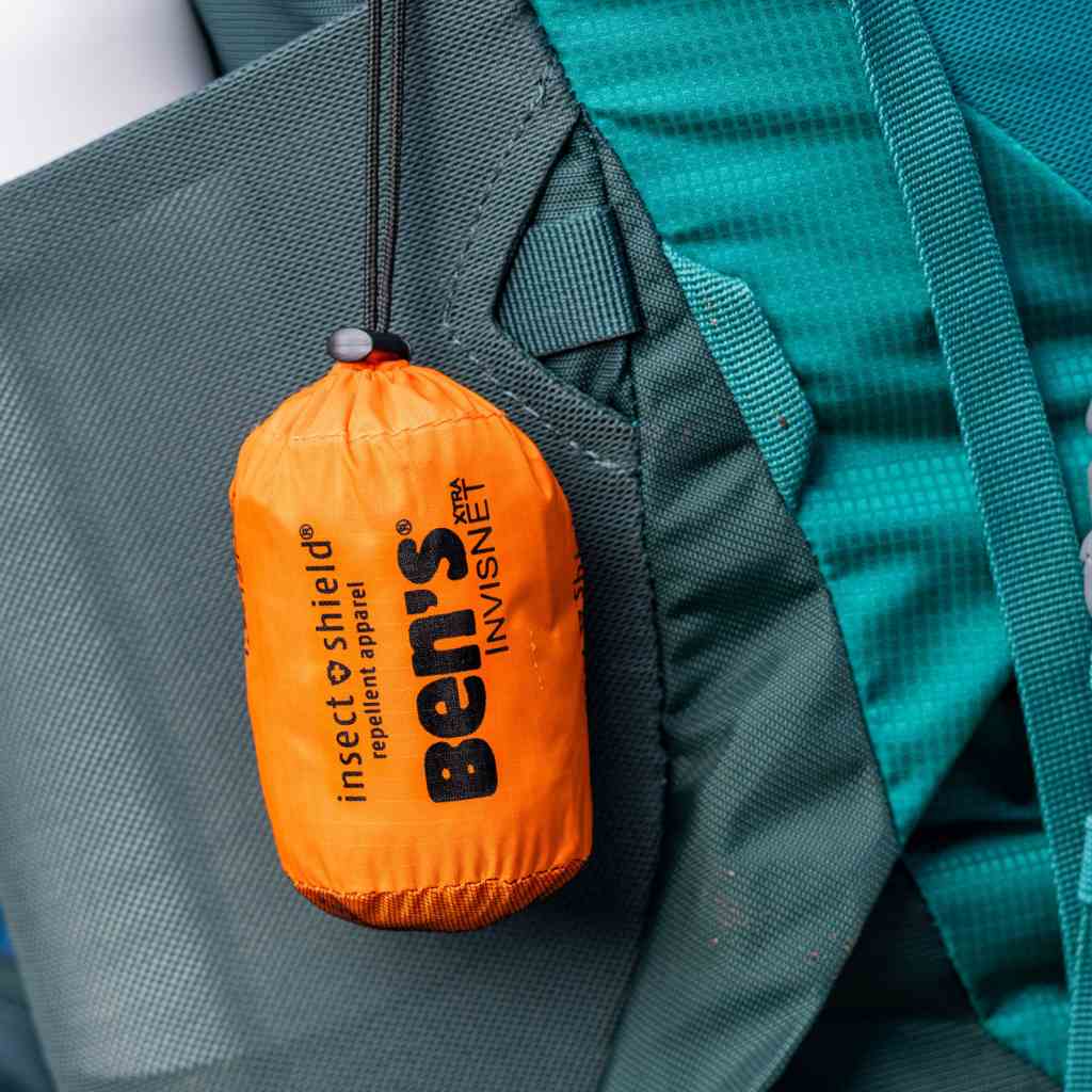 Ben's InvisiNet XTRA with Insect Shield hanging in sleeve on teal backpack