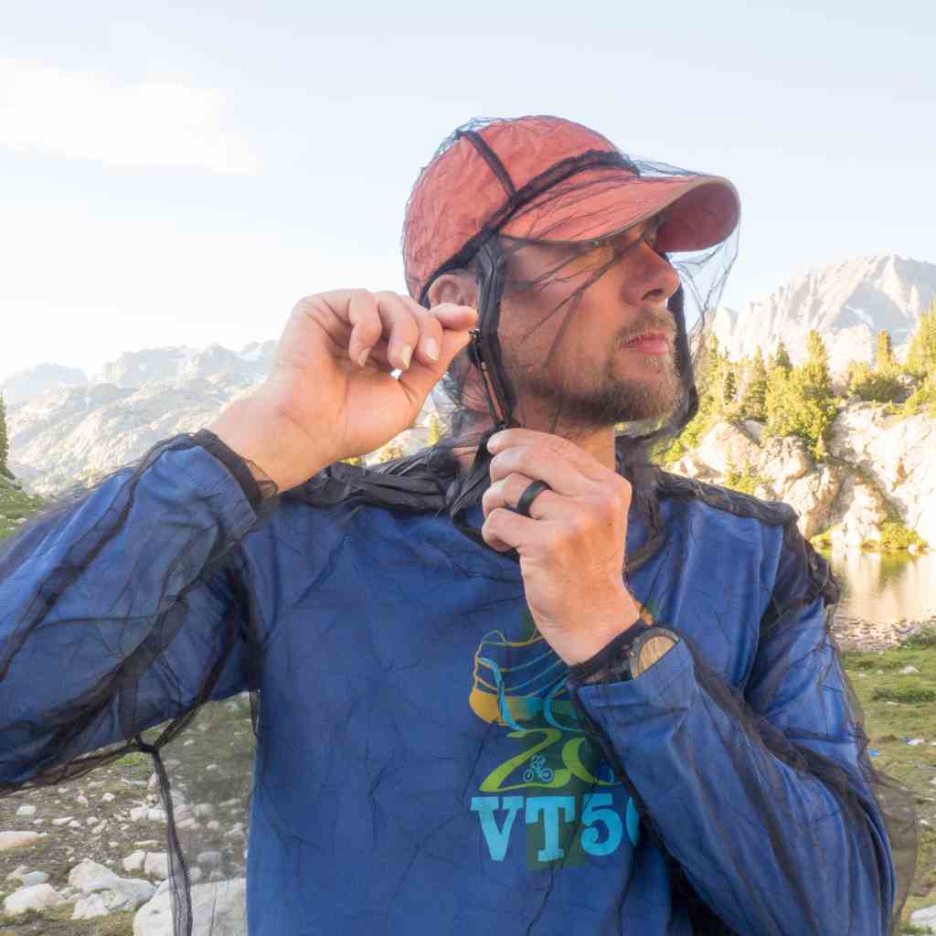 Ben's InvisiNet Bug Jacket & Mitts man adjusting jacket while outdoors