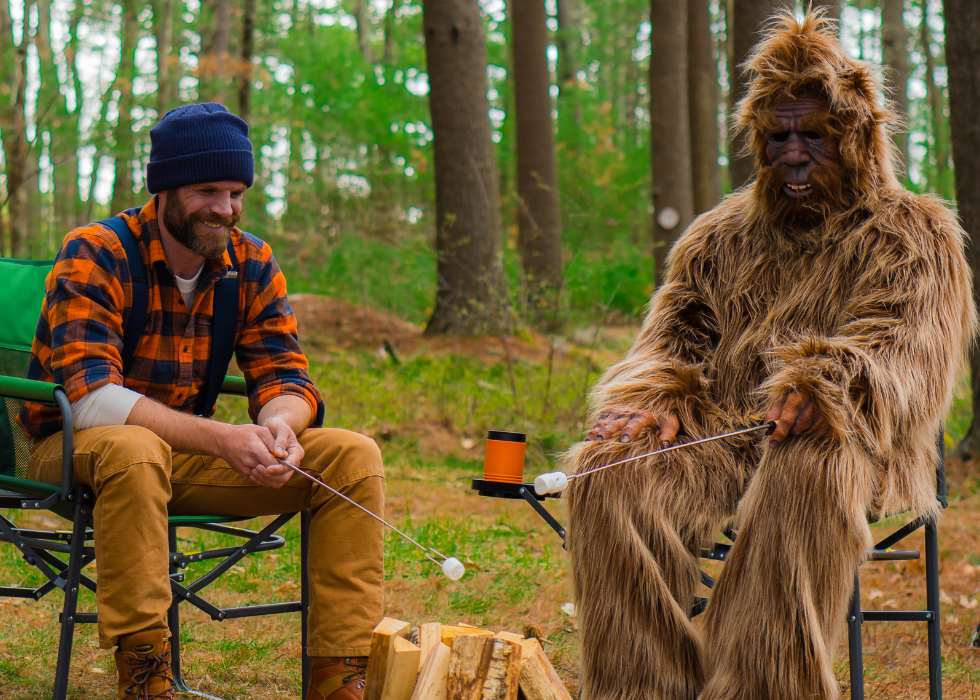 Ben and Sasquatch roasting marshmallows while camping